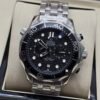 Omega — cronógrafo con esfera negra ondulada, bisel negro y brazalete de acero