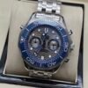 Omega — cronógrafo con esfera azul ondulada, bisel azul y brazalete de acero