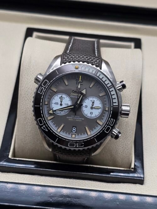 Omega — cronógrafo con esfera gris y subesferas claras, correa de tela gris