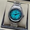 Omega — esfera turquesa degradada y brazalete de acero