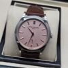 Patek Philippe — esfera rosada, caja de acero y correa de cuero marrón