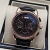 Patek Philippe — cronógrafo con esfera negra y fases lunares, caja oro rosa y correa de cuero negra
