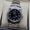 Rolex — esfera negra con números 3-6-9 y brazalete de acero
