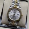 Rolex — esfera plateada, bisel dorado estriado y brazalete jubilee bicolor