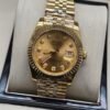 Rolex — esfera champaña con brillantes, bisel dorado estriado y brazalete jubilee bicolor