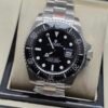 Rolex — esfera negra, bisel negro y brazalete de acero