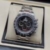 Rolex — cronógrafo con esfera esqueleto, bisel negro y brazalete de acero
