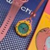Swatch — reloj de bolsillo octagonal amarillo con esfera turquesa y correa rosada