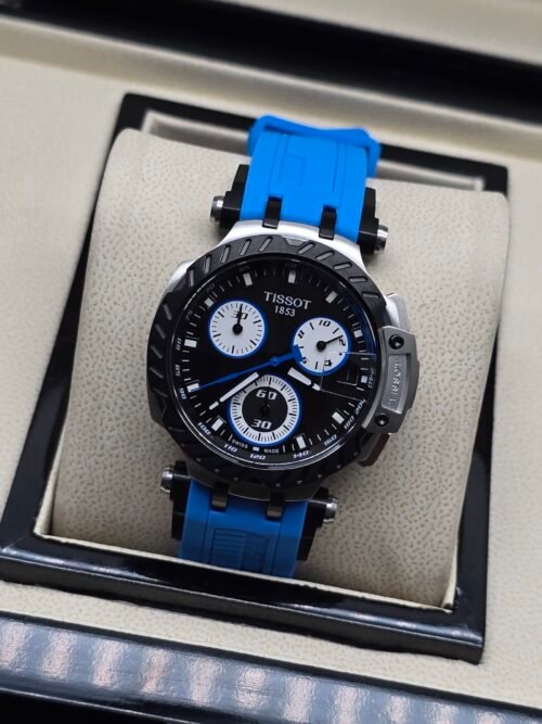 Tissot — cronógrafo con esfera negra y subesferas blancas, correa azul