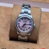 Rolex — esfera rosada con números romanos y brazalete de acero
