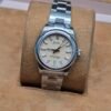 Rolex — esfera crema y brazalete de acero